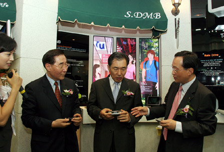 Jae Hee Lee (on left), president of Incheon International Airport Corporation, Sang Su Ahn (center), governor of Incheon City, and Shin Bae Kim (on right), president of SK Telecom, are shown testing the satellite DMB services at the opening ceremony of the ubiquitous service center called `U-Zone` which is located on the 3rd floor of the Incheon International Airport.